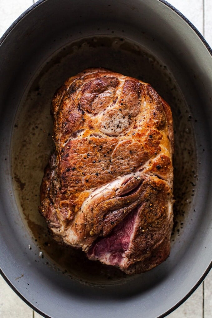 browned pork shoulder in large pot