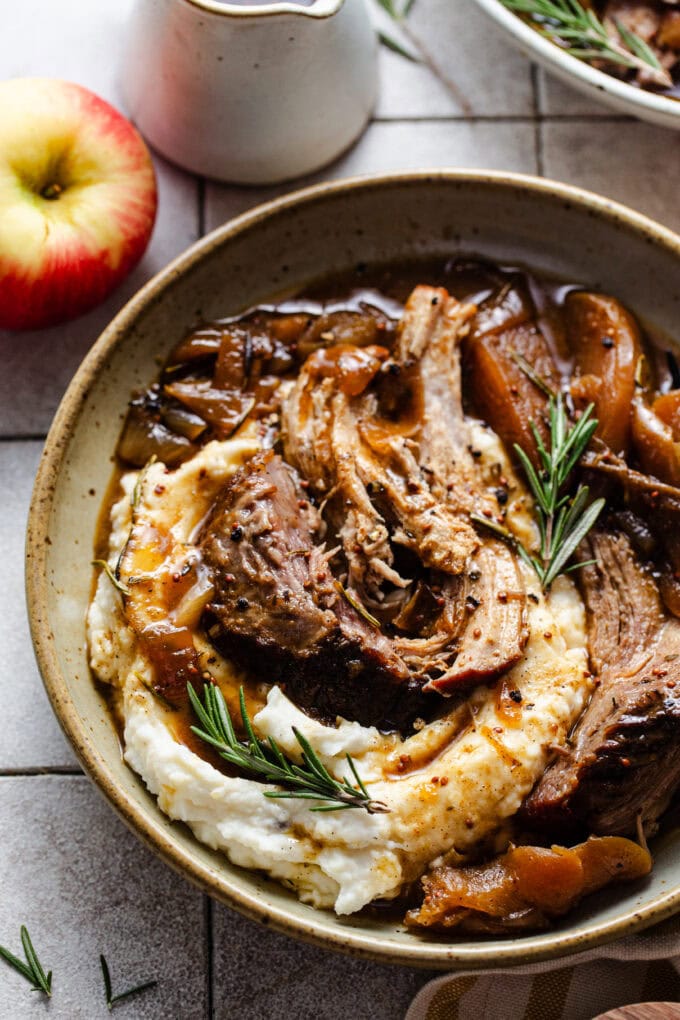 shredded pork on top of mashed potatoes in bowl