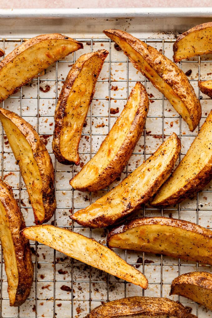 crispy baked potato wedges on rimmed baking sheet