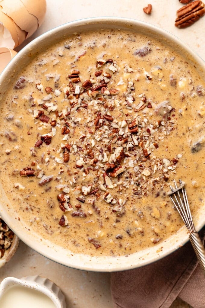 sweet potato custard with pecans in bowl with whisk