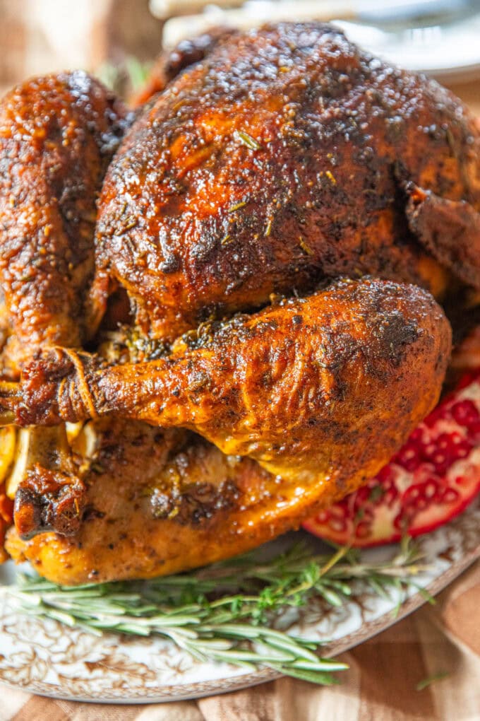 cajun butter roasted turkey on platter with fresh herbs