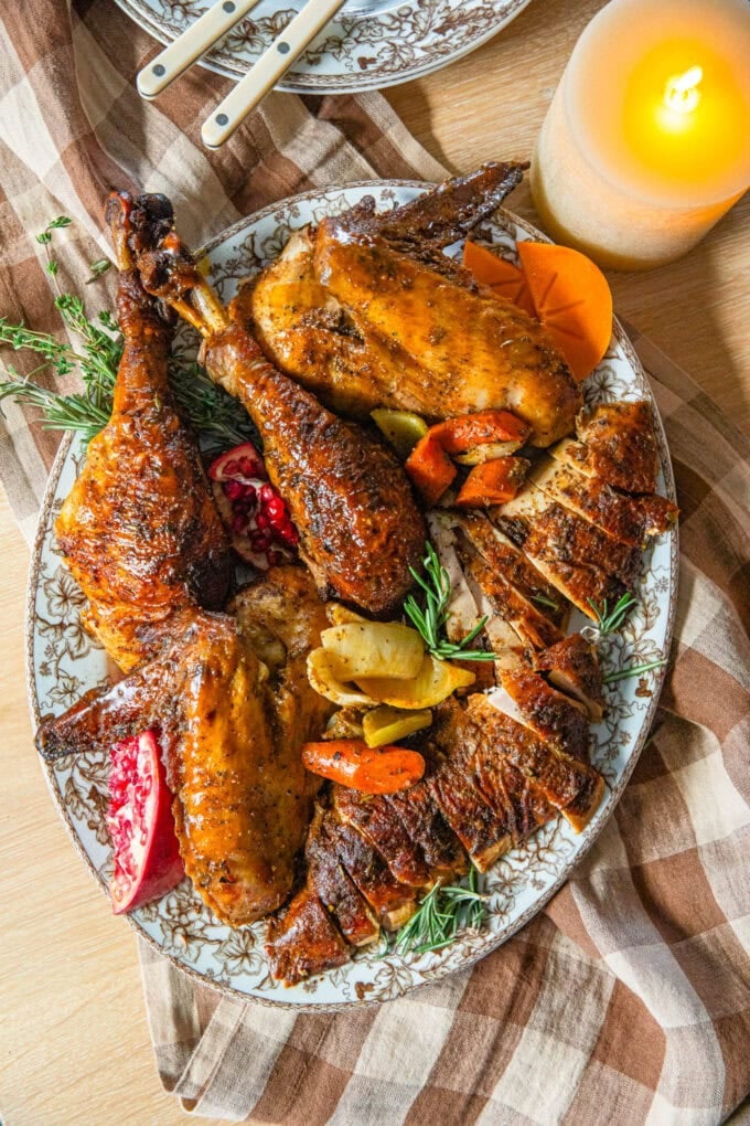 cajun butter thanksgiving turkey parts on platter with fresh herbs