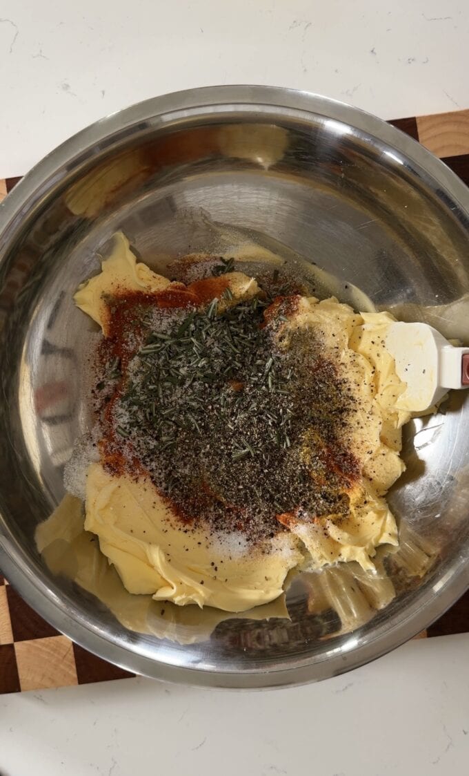 seasonings on top of butter in bowl