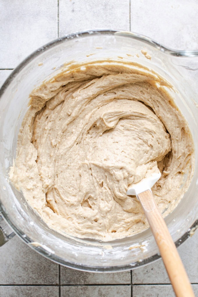 caramel cake cake batter in glass bowl with spatula