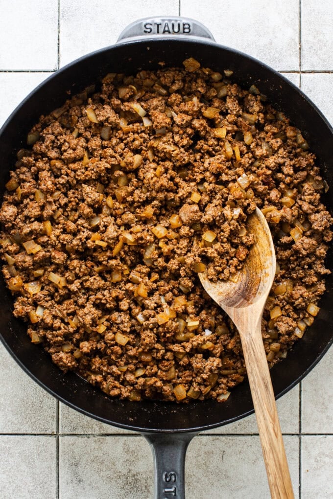 ground beef taco mixture in skillet with wooden spoon