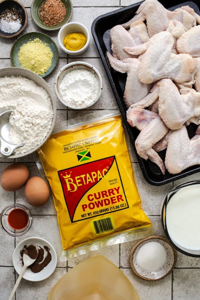 ingredients for jamaican curry chicken wings in bowls