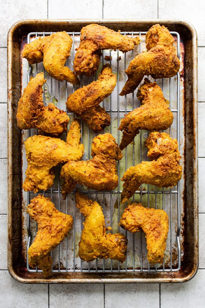fried curry chicken wings on wire rack cooling
