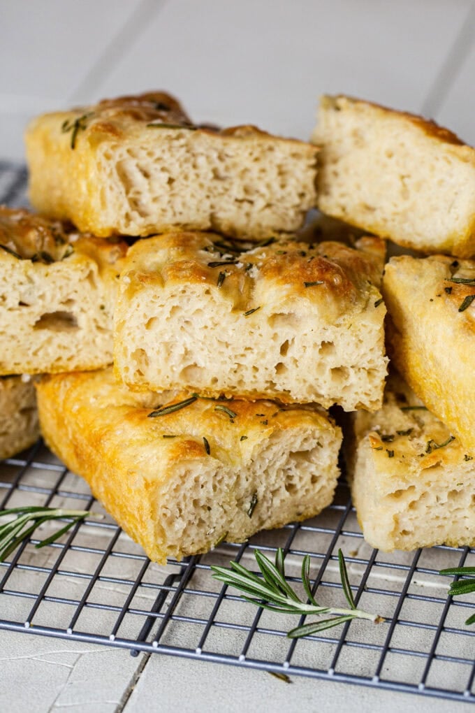 sliced focaccia bread stacked on top of each other on wire rack