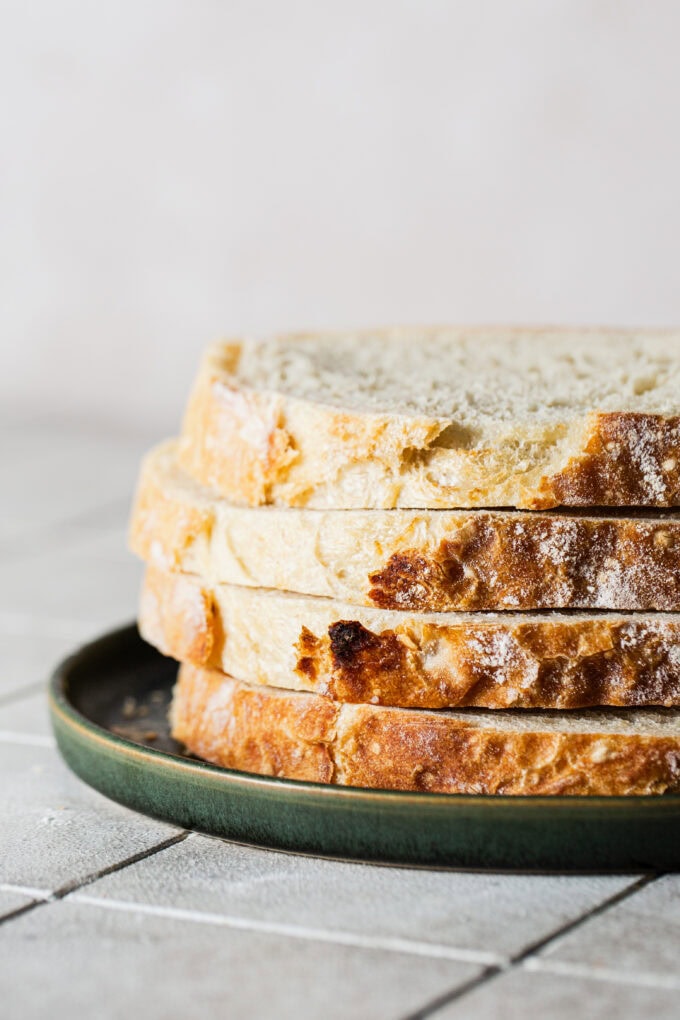 slices of artisan bread stacked on top of each other on plate