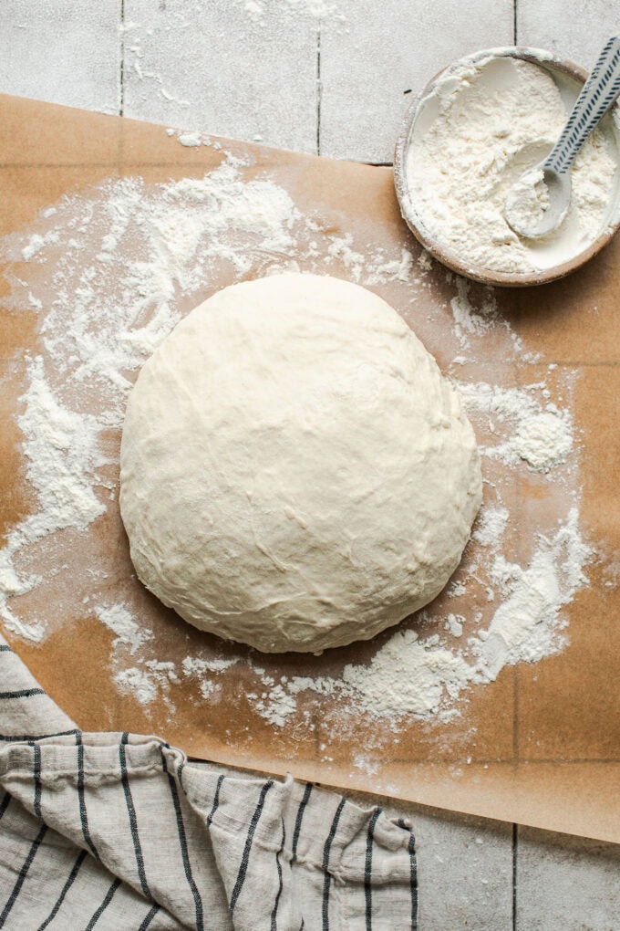 bread dough with flour on parchment paper
