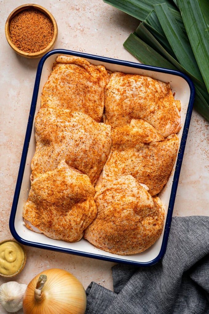 seasoned raw chicken in pan