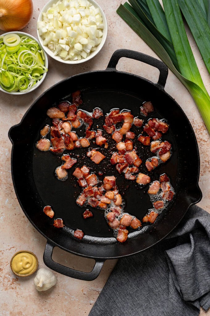 cooked bacon pieces in skillet