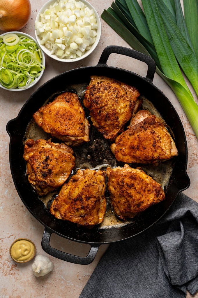 browned chicken thighs in skillet