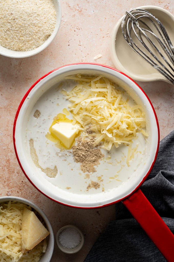 butter and cheese on top of grits in saucepan