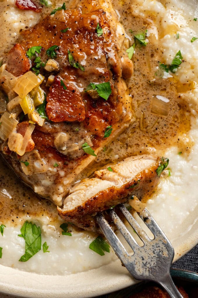 creamy chicken with grits and fork in bowl