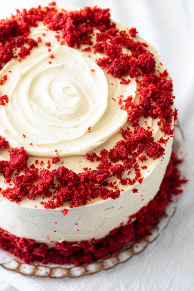 red velvet cake on platter with white linen