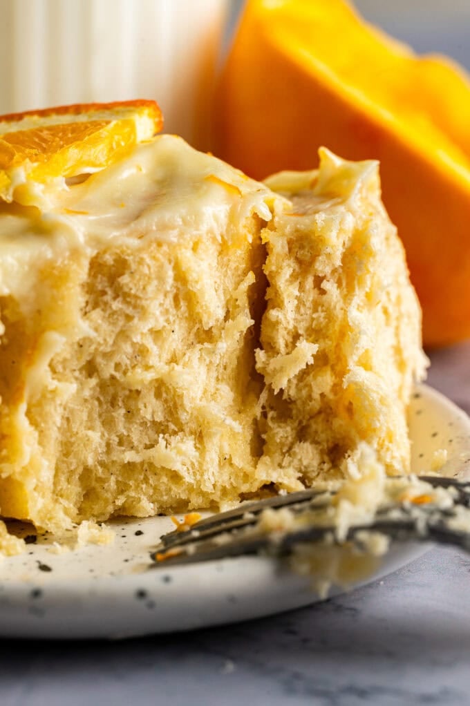 soft and fluffy orange roll on plate with fork