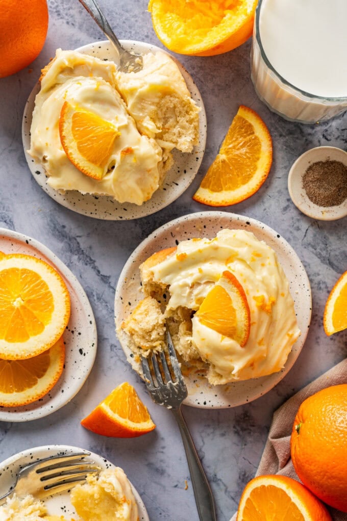 orange sweet rolls on small white plates