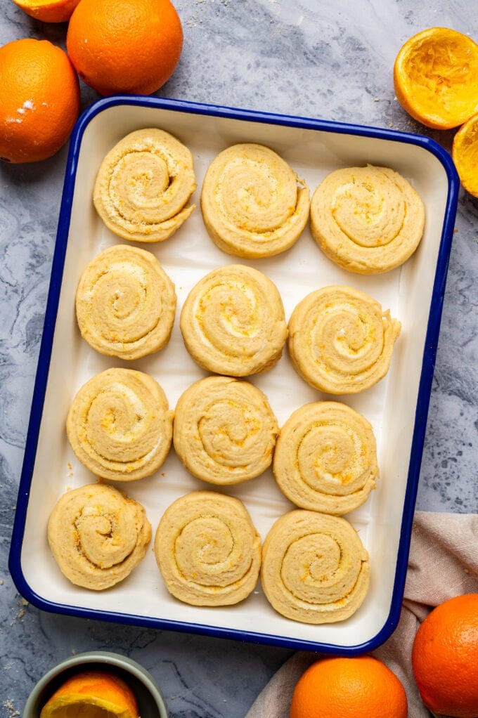 raw orange rolls in baking pan