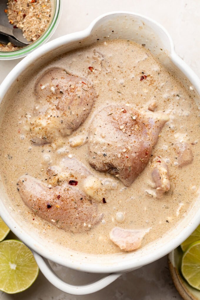 raw chicken thighs in spiced coconut milk
