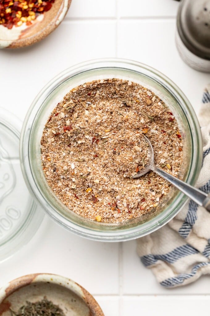 dry rub jerk seasoning in glass jar with spoon