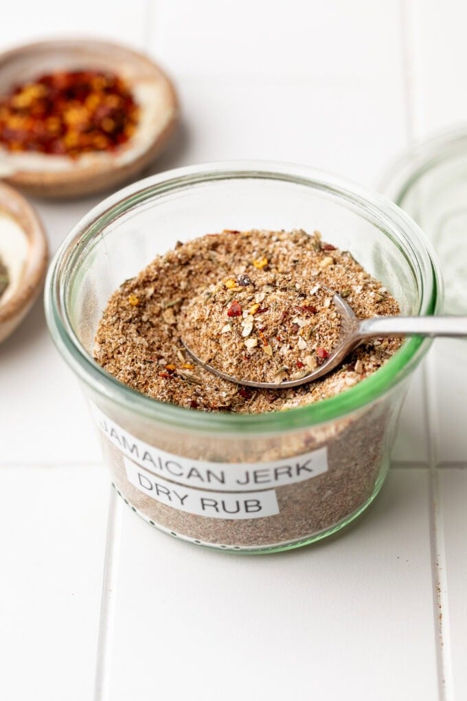 jerk seasoning in glass jar with spoon