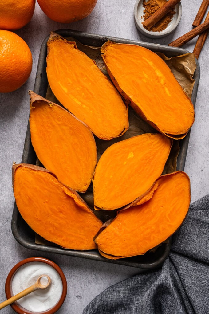 baked sweet potatoes on rimmed baking sheet