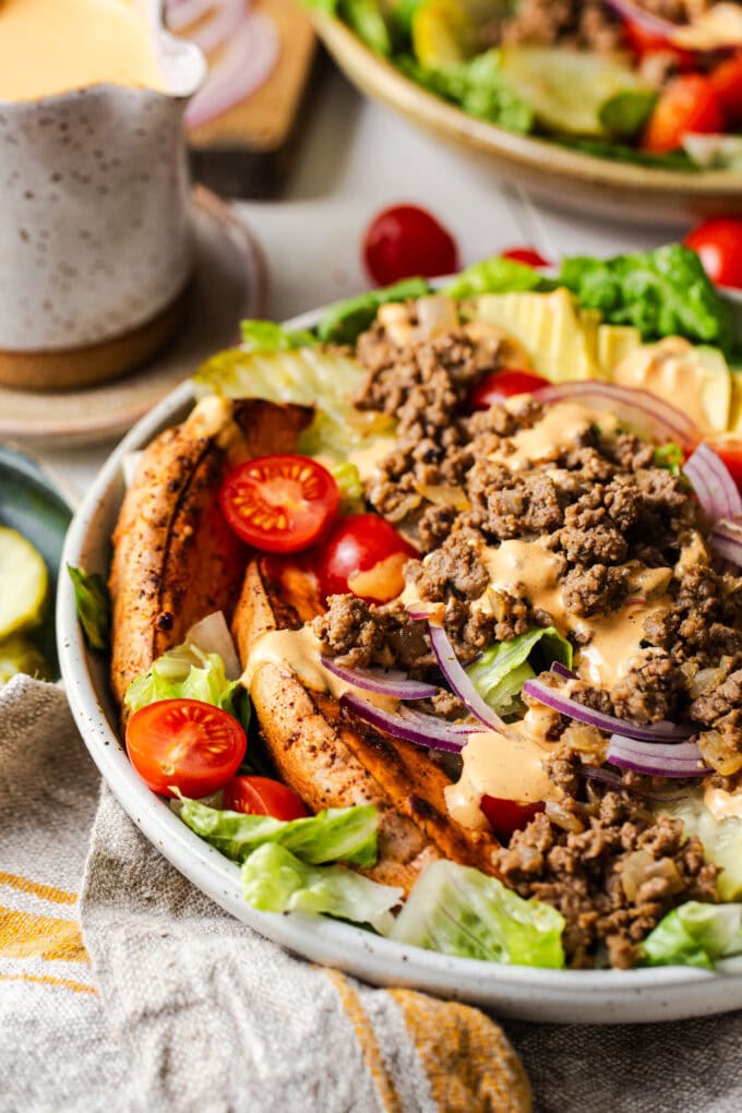 chipotle ranch burger bowl with sweet potato fries in white bowl