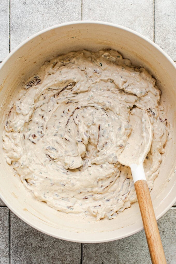 caramelized onion dip mixed in bowl with spatula