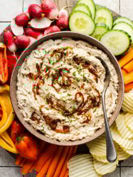 caramelized onion dip in bowl with spoon
