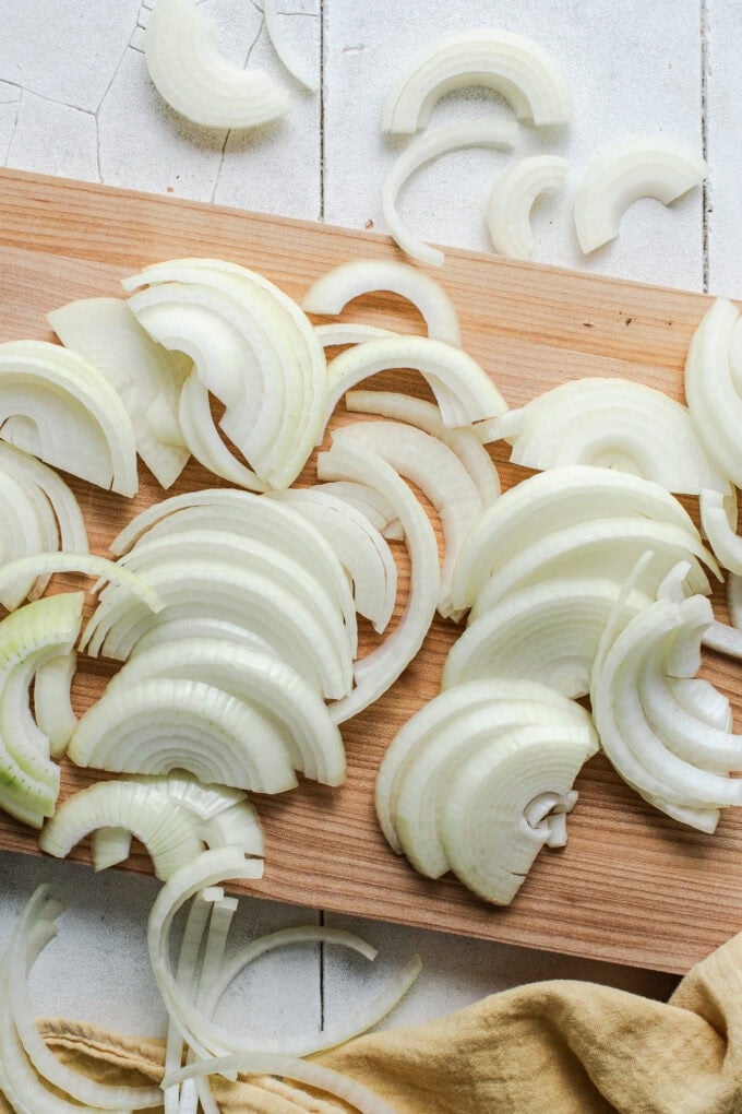 sliced yellow onions on cutting board
