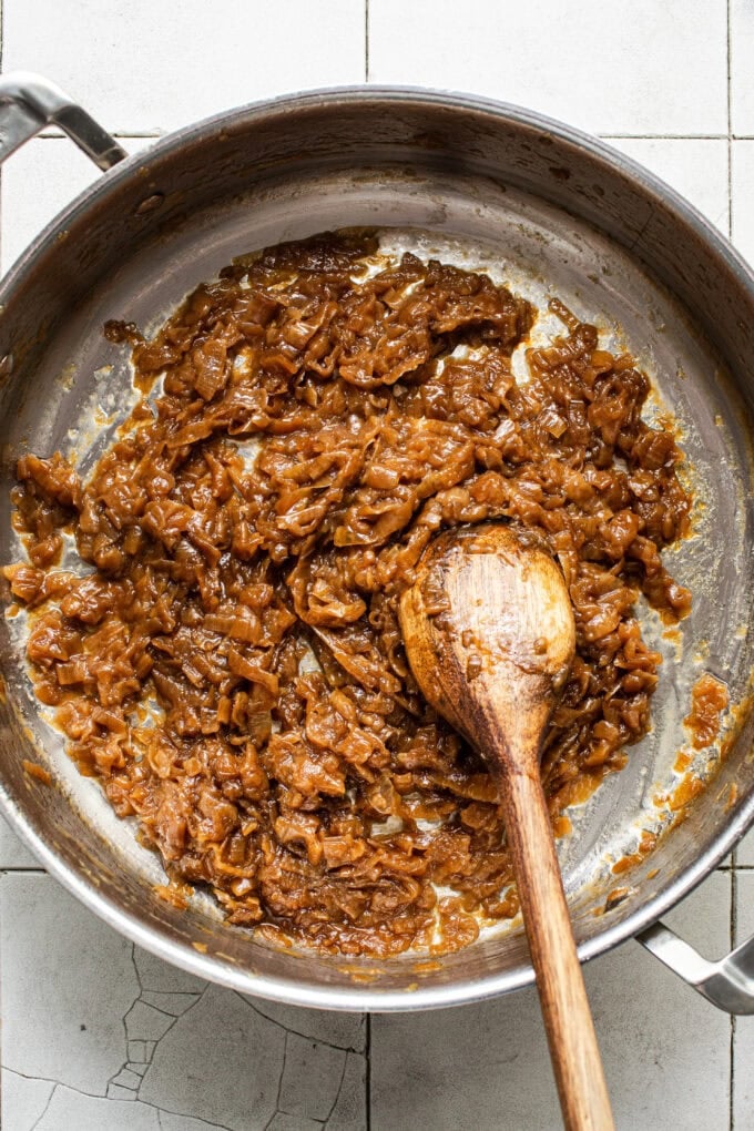 caramelized onions in pot with wooden spoon