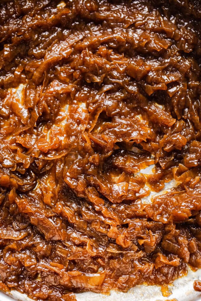 caramelized onions in pot with wooden spoon