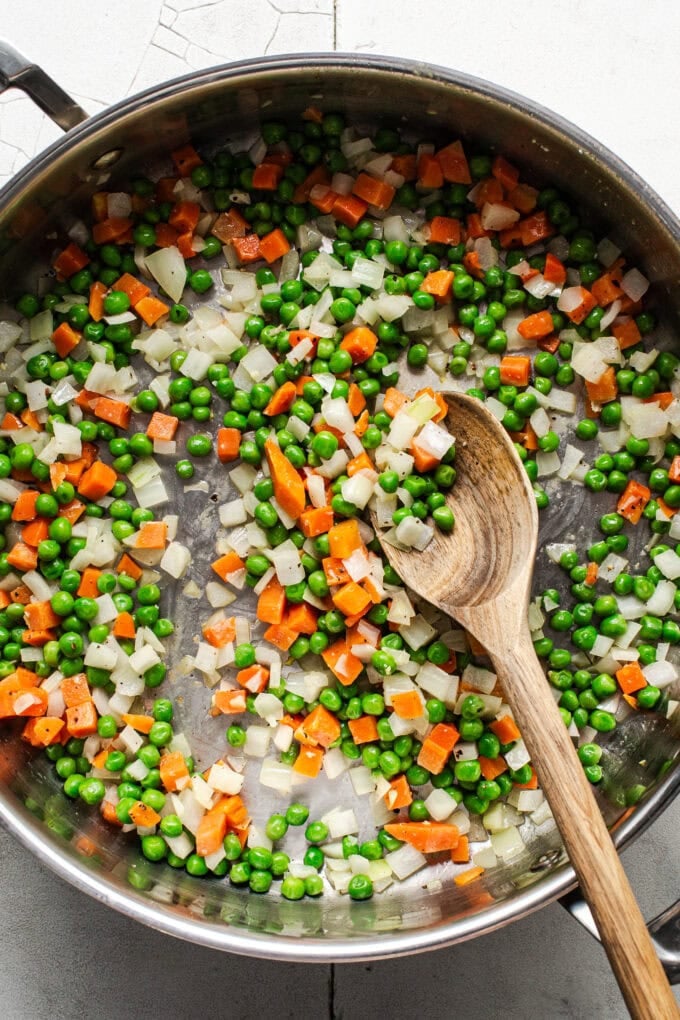 sautéed veggies in pan with wooden spoon
