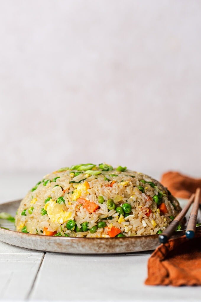 domed fried rice on plate with chopsticks