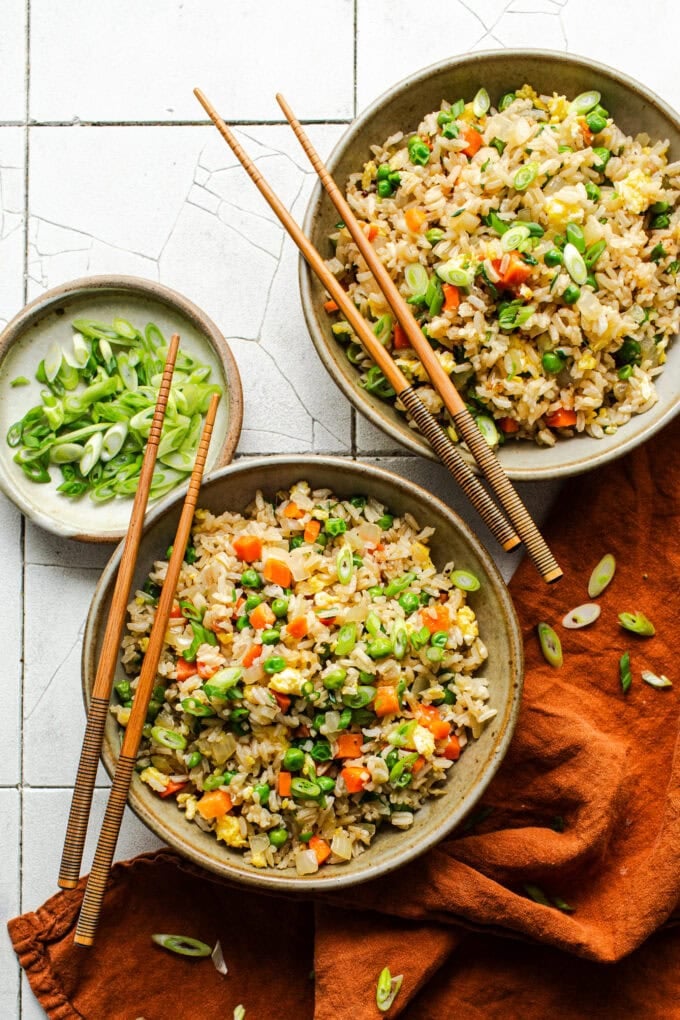 fried rice in bowls with chopsticks