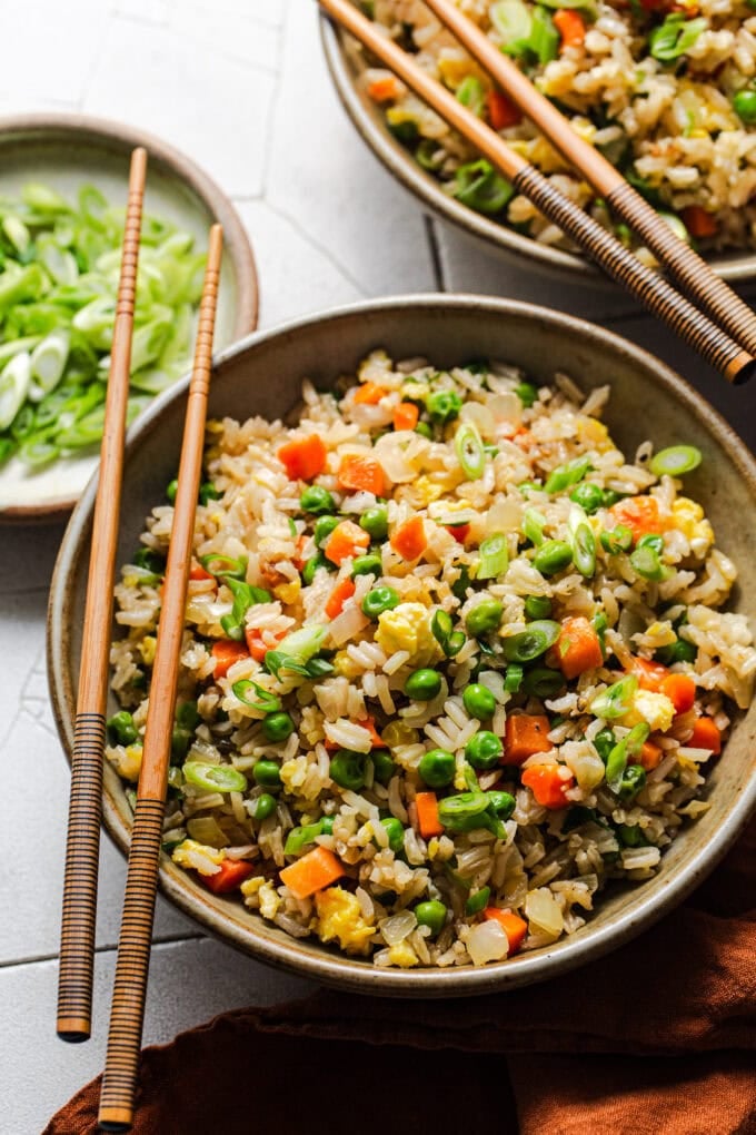 fried rice in bowl with chopsticks on the side