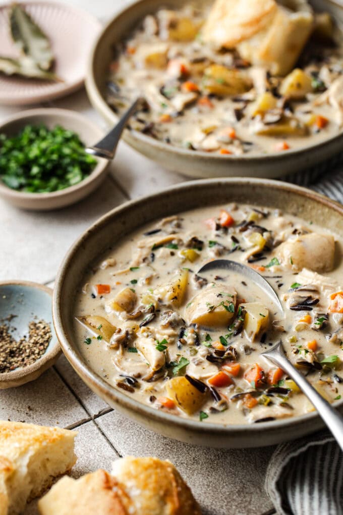 creamy chicken wild rice soup in bowls with spoon
