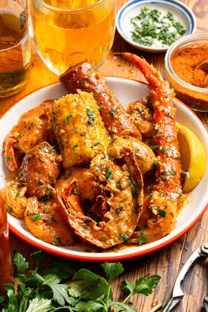 cajun lobster seafood boil on white plate