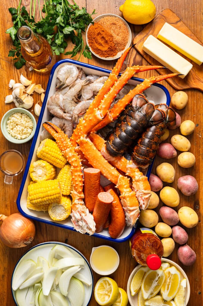 lobster seafood boil ingredients laid out on surface