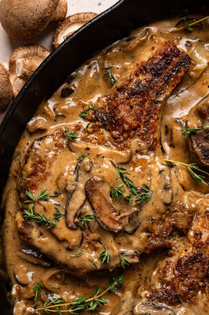 closeup of smothered pork chop with mushroom gravy