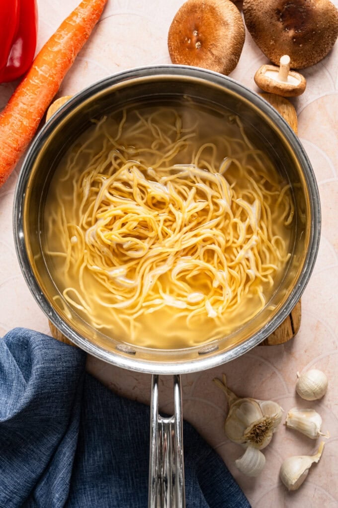 boiled lo mein noodles in saucepan