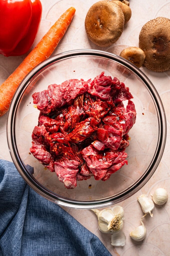raw steak in glass bowl with sauce