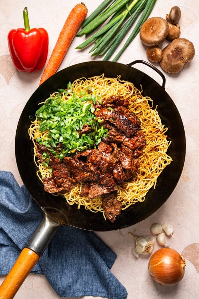 veggies, noodles, and green onions in wok