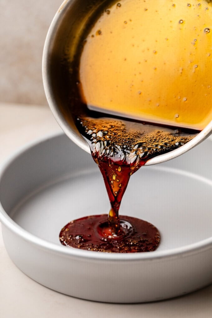 caramel sauce being poured into cake pan