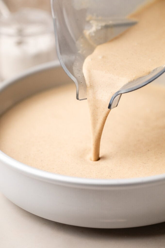 flan custard being poured into cake pan