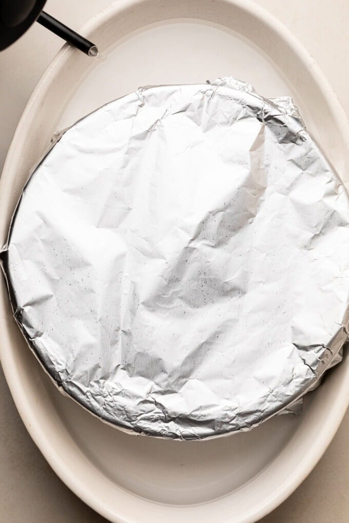 foil-covered cake pan in water bath