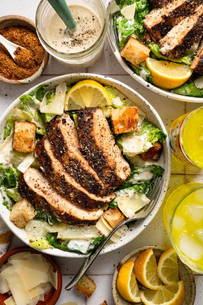 jerk chicken caesar salad in white bowl