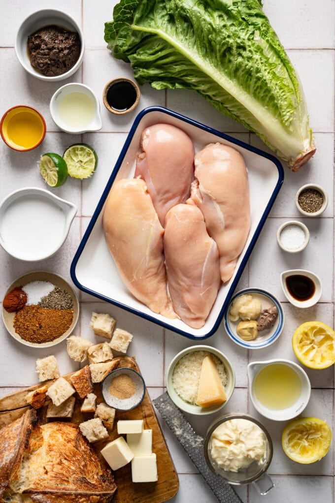 ingredients for jerk chicken caesar salad in small bowls