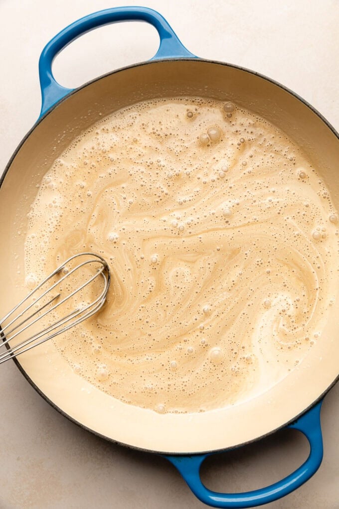 cream in saucepan with whisk
